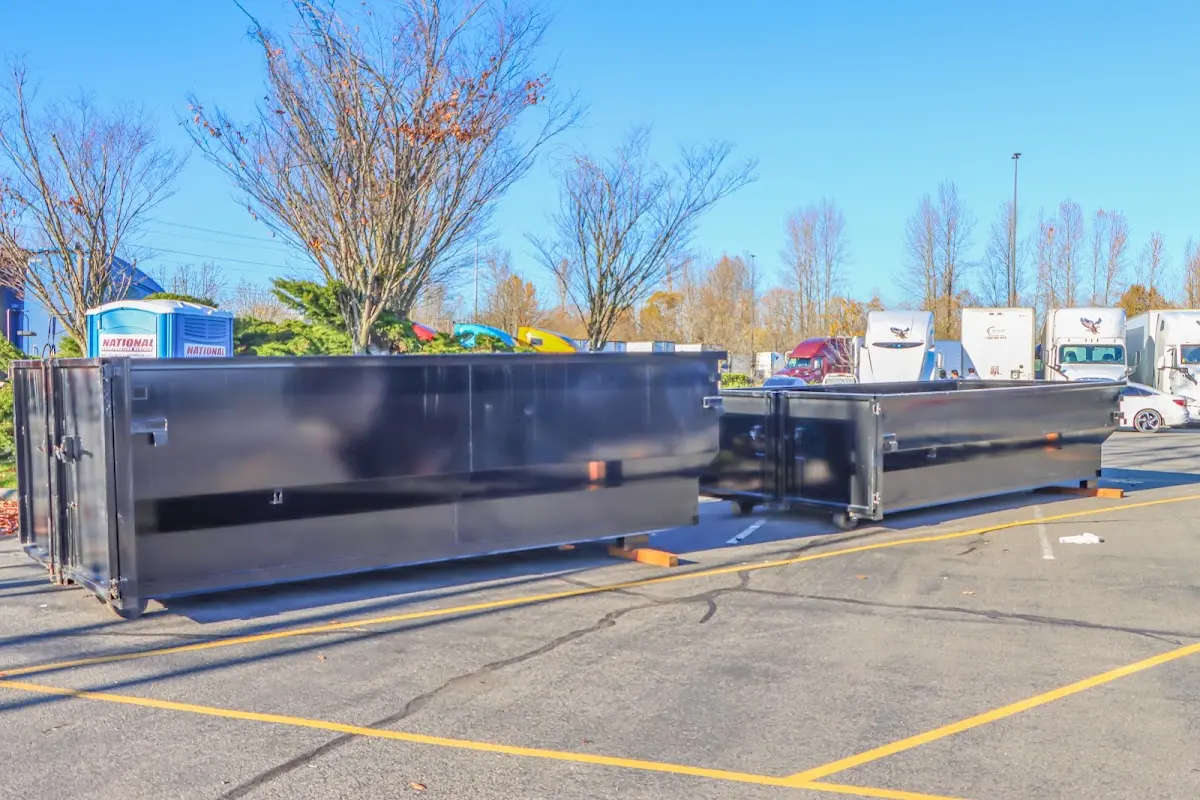 Professional dumpster rental service with roll-off container on residential driveway in Los Osos